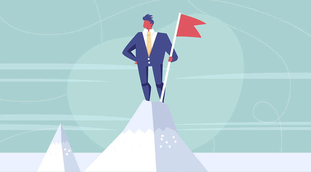 A vector character stands on top of a mountain with a flag.